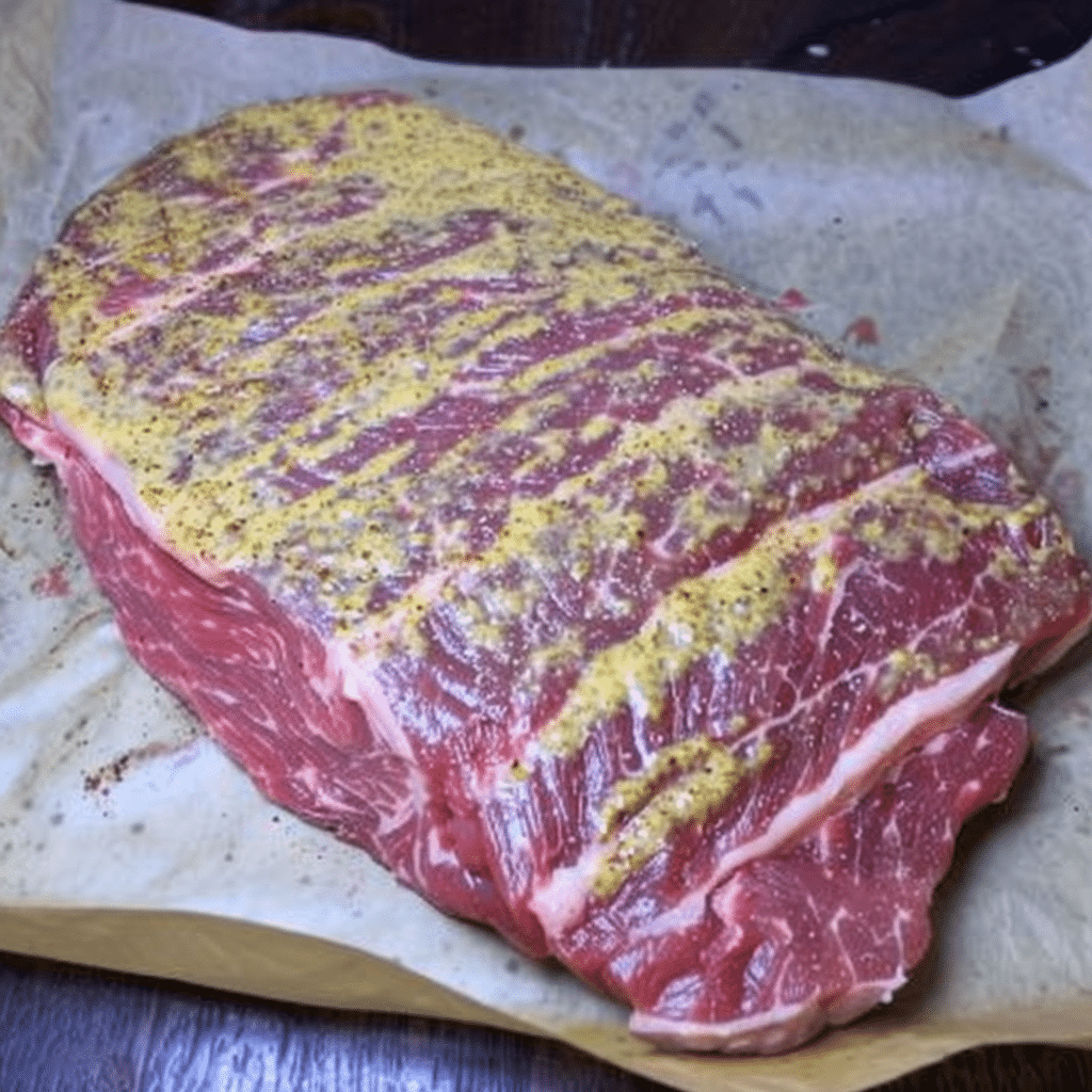 Corned Beef Brisket Smoked to Perfection: A Backyard BBQ Classic 11 Applying rub to corned beef brisket